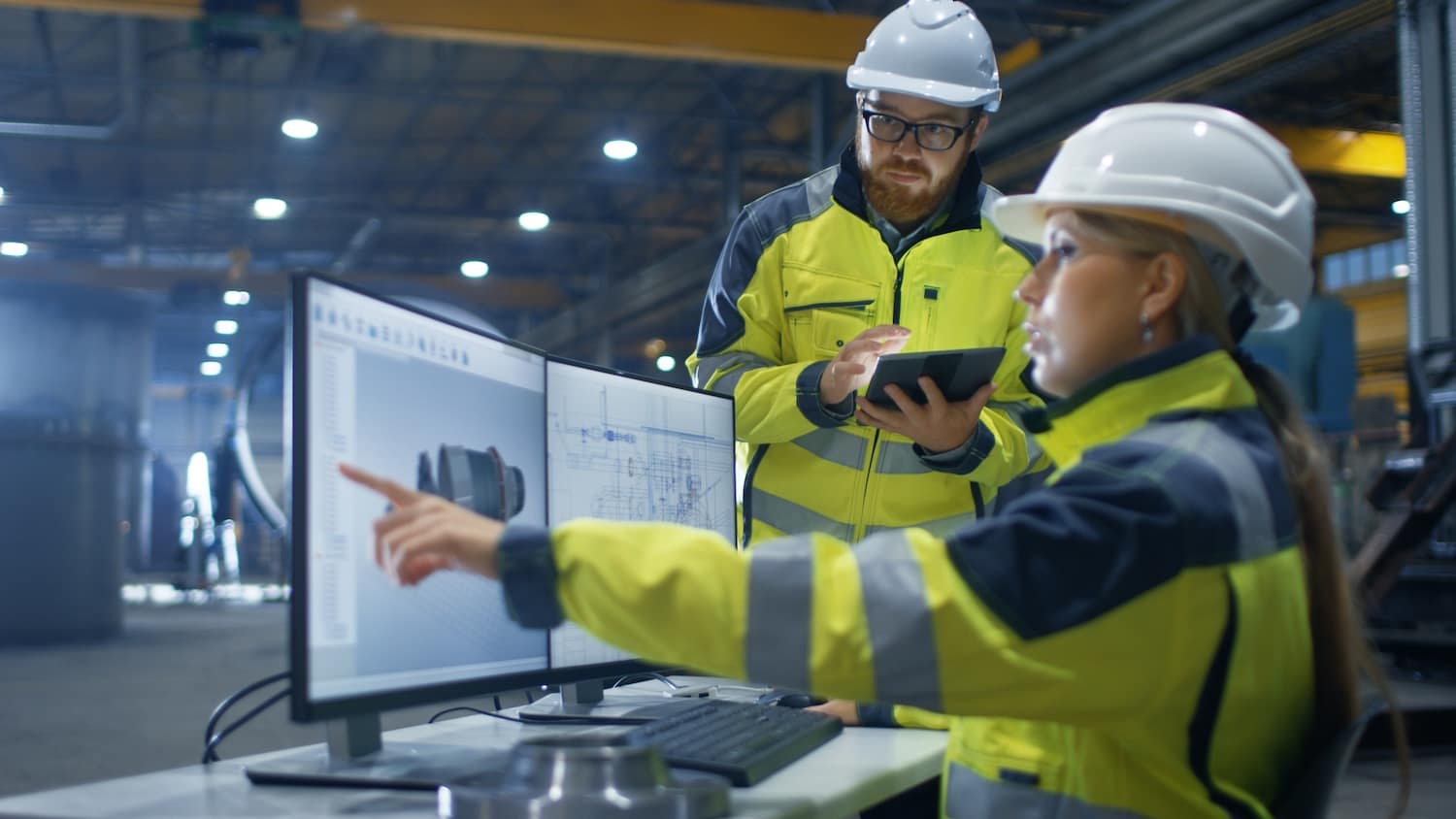 Inside the Heavy Industry Factory Female Industrial Engineer Works on Personal Computer She Designs 3D Turbine Model, Her Male Colleague Talks with Her and Uses Tablet Computer. lean